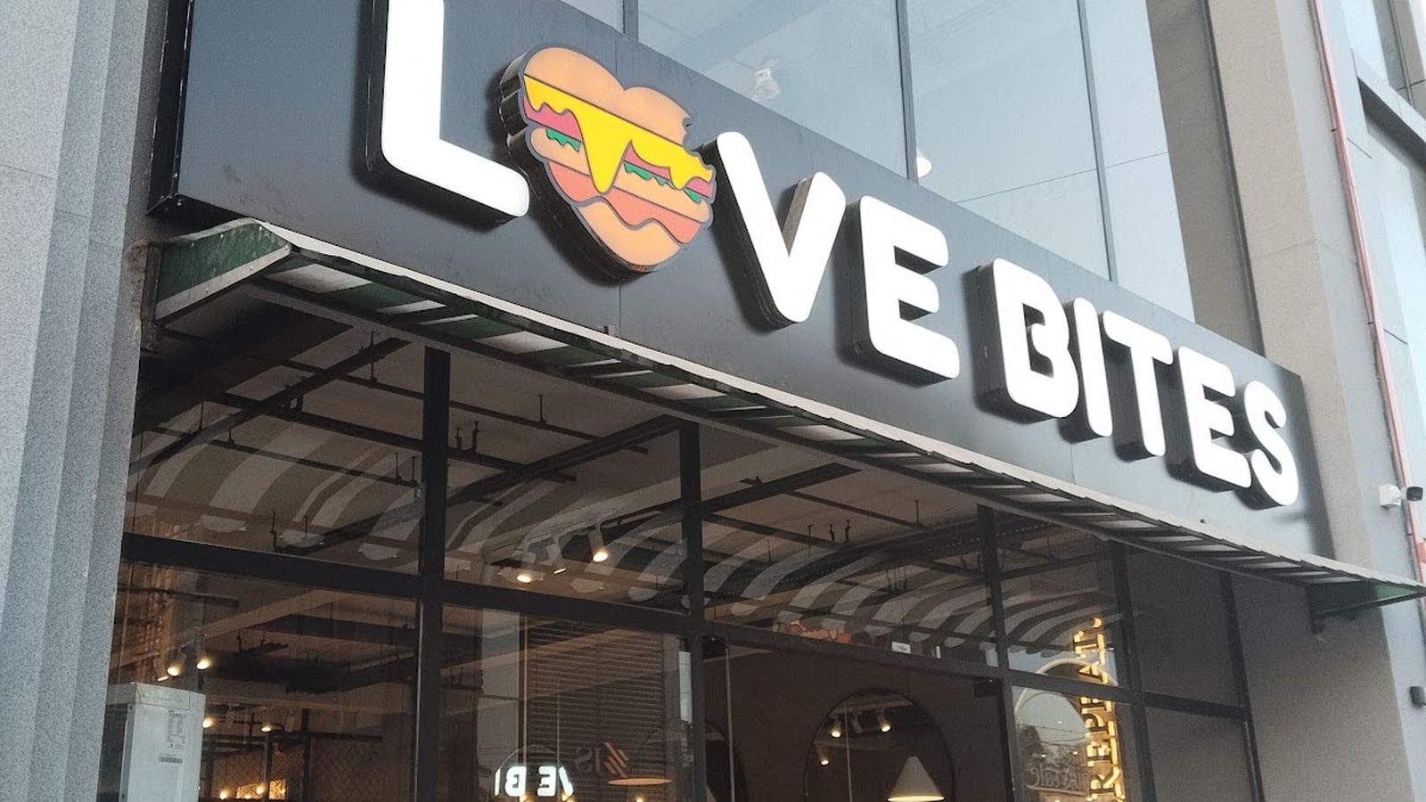 The Love Bites Faisalabad flagship shopfront on Green Avenue with a large illuminated sign